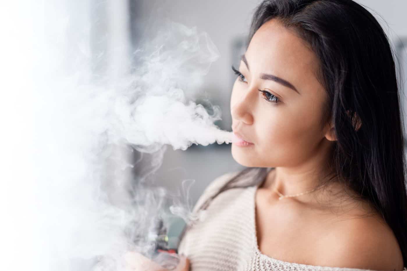 casual asian woman vaping electronic cigarette at 2021 08 30 00 21 02 utc